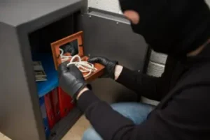 thief stealing valuables from safe at crime scene 768x512 1
