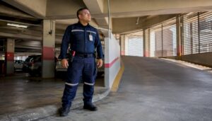 1785594161978 Security guard on foot patrol in parking garage
