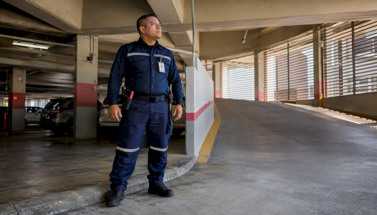 Parking Garage Security Patrol: A Facility Manager's Guide Security guard on foot patrol in parking garage