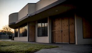 Vacant building with secured doors and window board-ups