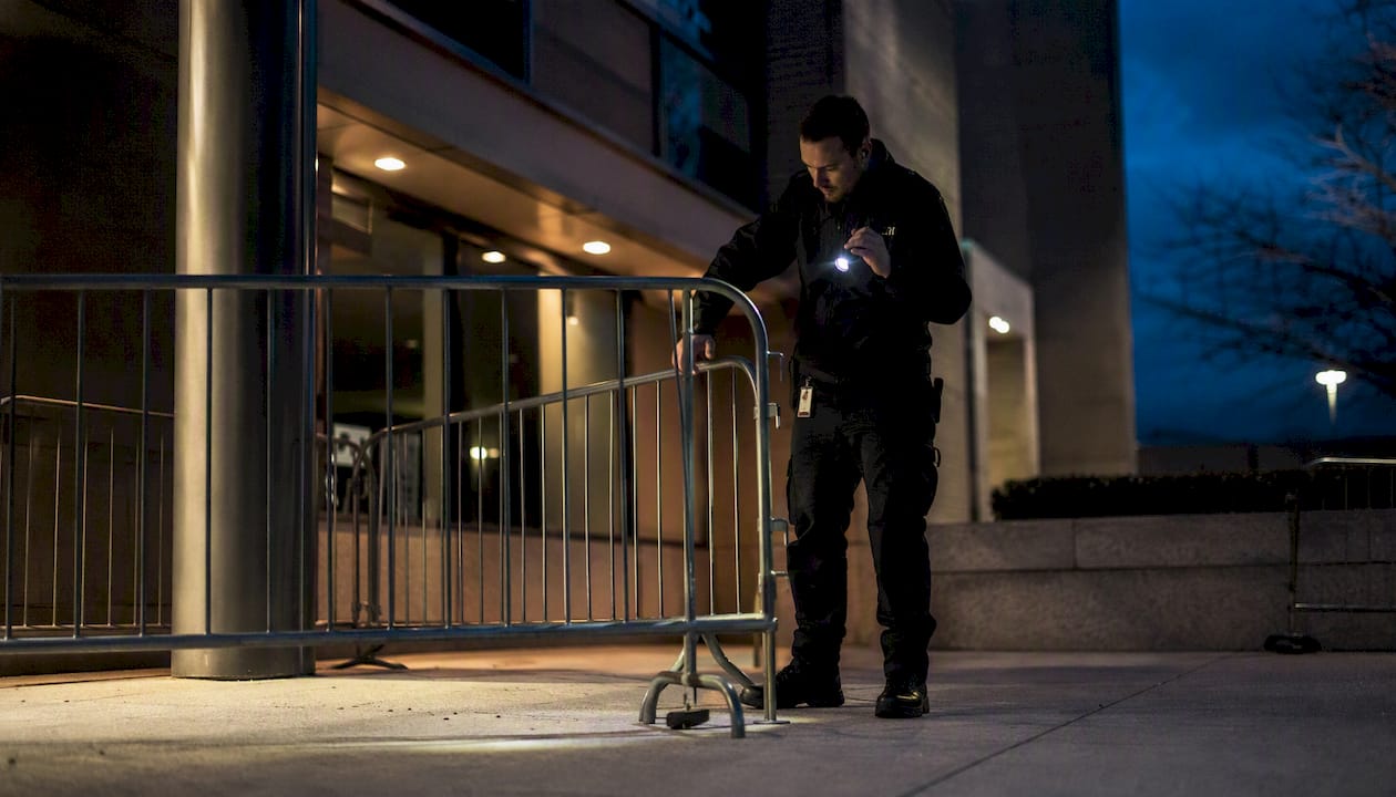 Security officer setting perimeter at building entrance