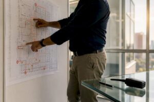 Hands pointing at facility evacuation map
