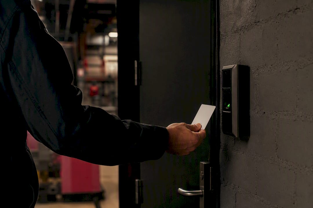 Hand presenting access card to door lock