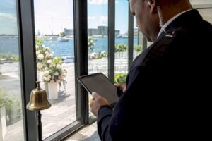 Security guard checking guest list at wedding venue entrance