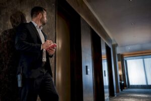 Agent surveying hotel elevator access